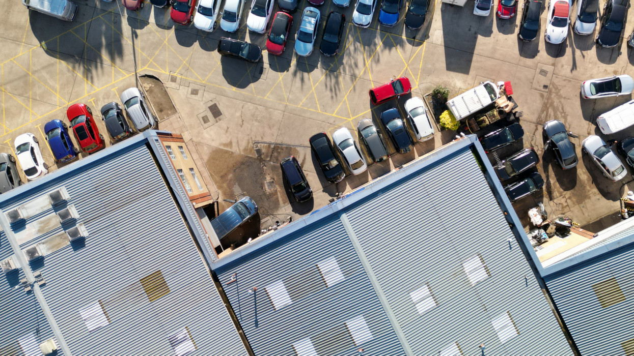 Overhead aerial view of a car dealership selling new and used cars