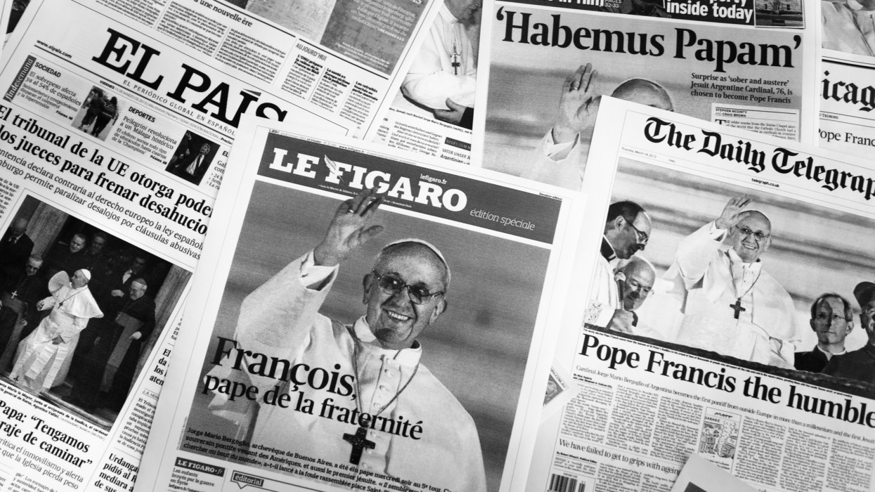 Florence, Italy - March 15, 2013: Close up of the major european cover newspapers the day after and two day after the Pope election. The new pope elected on 13 March 2013 is Jorge Mario Bergoglio called Pope Francesco 1st. The newspapers on the picture are the most important like, Le figaro, The daily telegraph, El pais. Monochrome image.