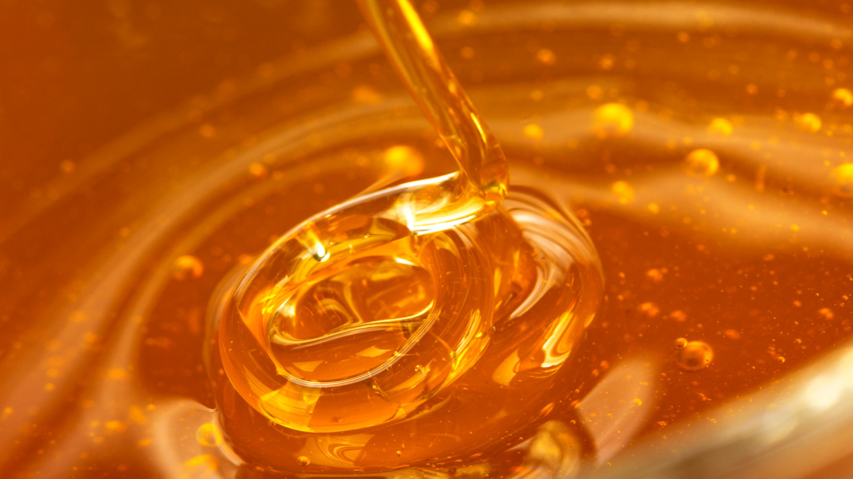 Honey pouring into dish