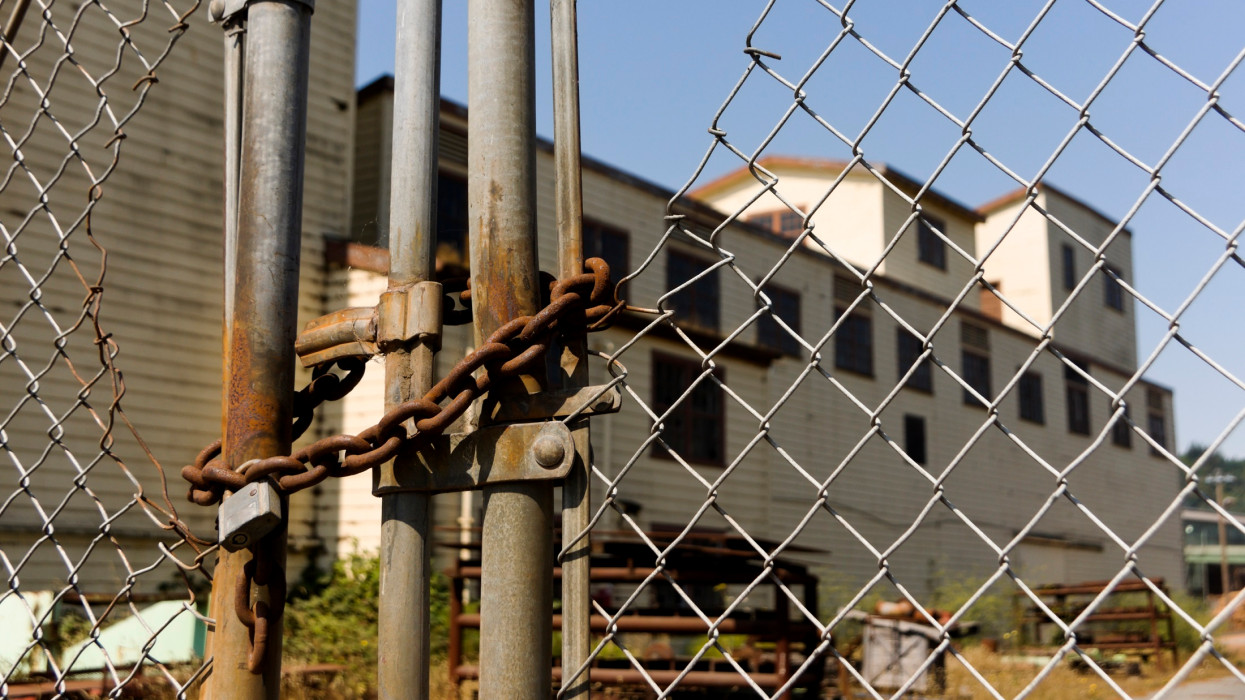 Fenced off Abandoned Factory - stock photo padlock