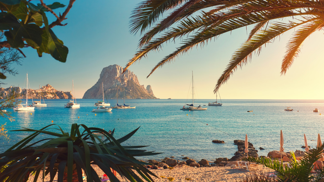Cala dHort beach. Cala dHort in summer is extremely popular, beach have a fantastic view of the mysterious island of Es Vedra. Ibiza Island, Balearic Islands. Spain