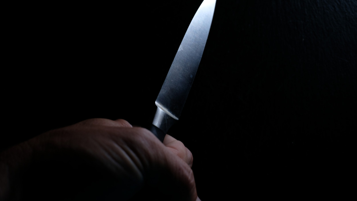 Kitchen knife in one hand, concept of domestic threat
