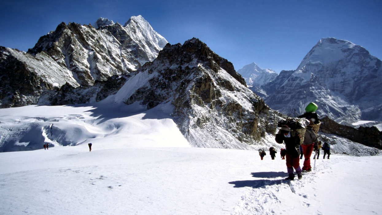 This is a photo of climbers and sherpas making a glacier traverse on the way to Mera Peak. In the far distance you can see the Everest/Lhotse massive.