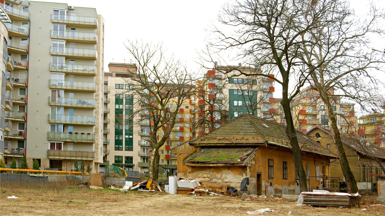 Ruinous cottage before new built flats and apartaments in Budapest, Hungary