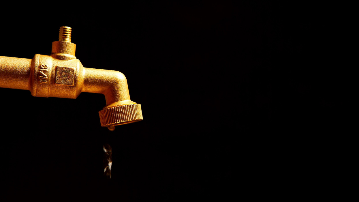 Dripping faucet on a black background
