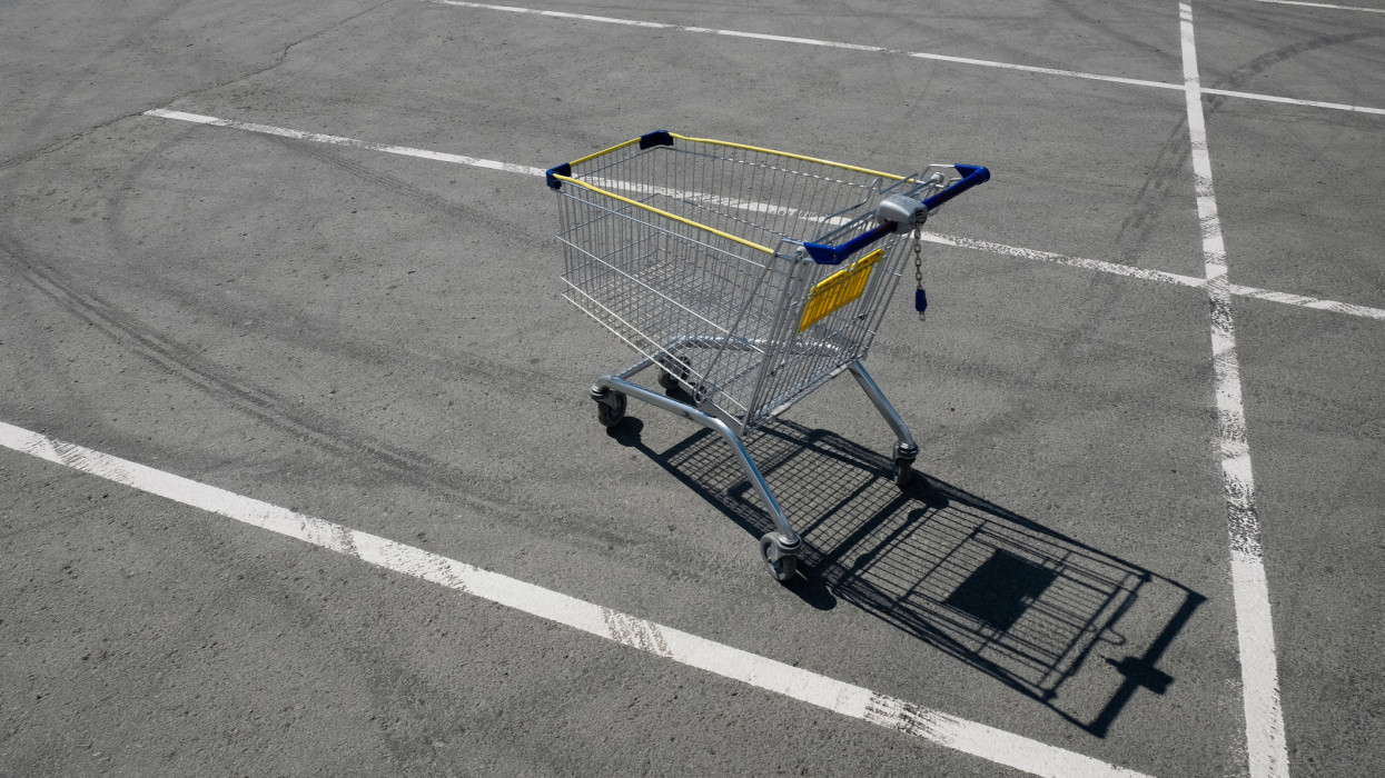 A shopping cart or cart For Shopping Products and Goods, Near a Shopping center, Hypermarket or Supermarket. The concept of the trade industry, the sphere of consumption.