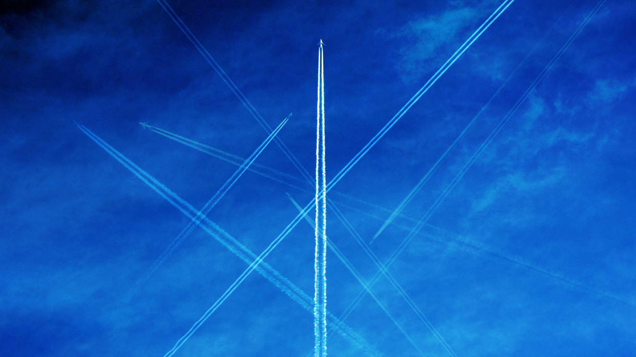 Airplane flight paths on blue sky