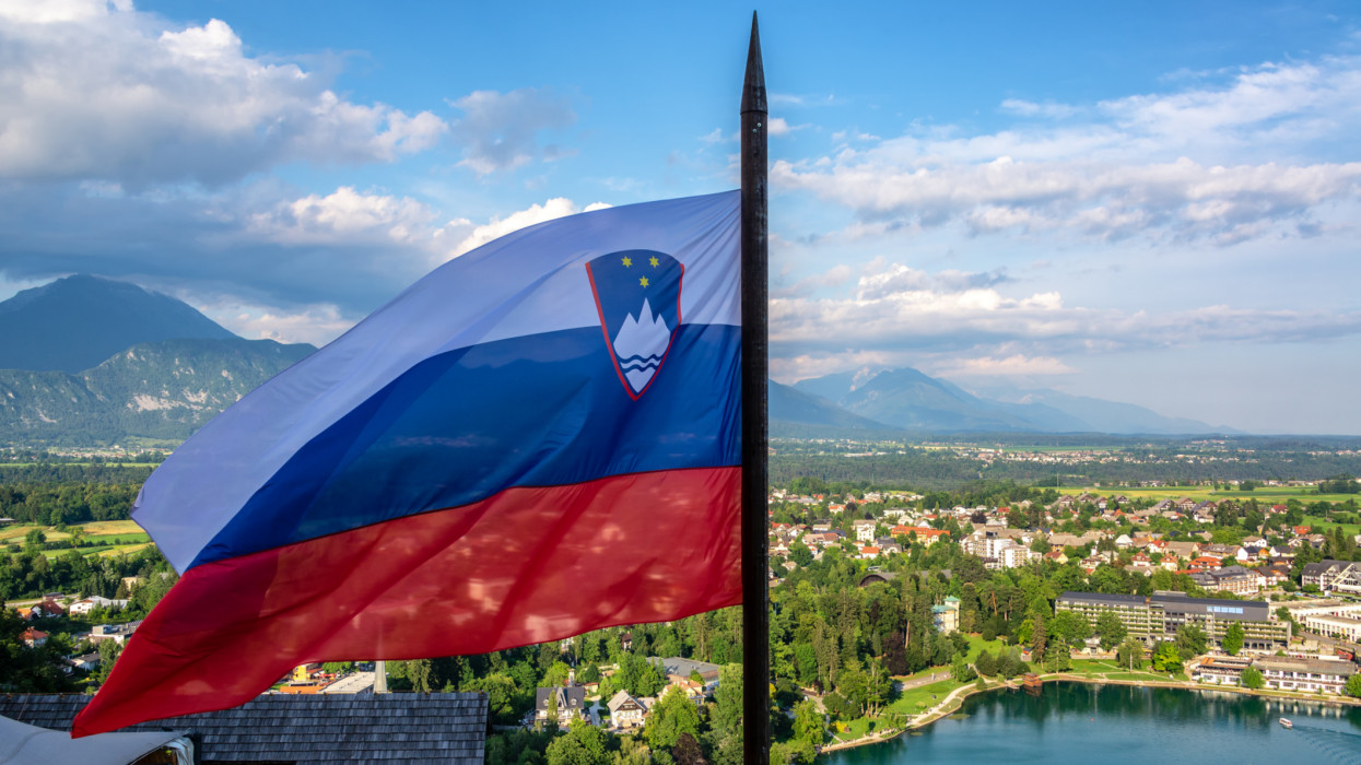 Slovenian flag flying high over Lake Bled in Slovenia