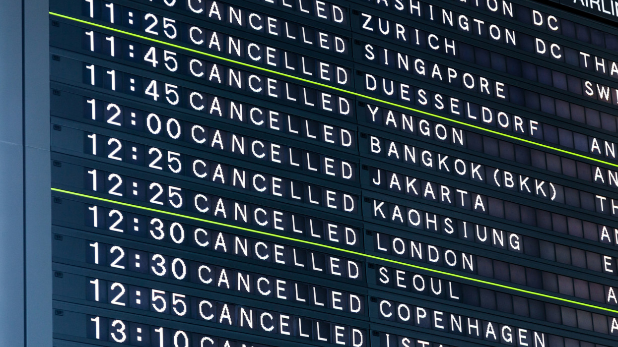 Airport flight information board showing all flights cancelled flights. Concept of extraordinary events such as terrorism, pandemics, riots, strikes, snow storms that cause airport shutdown.