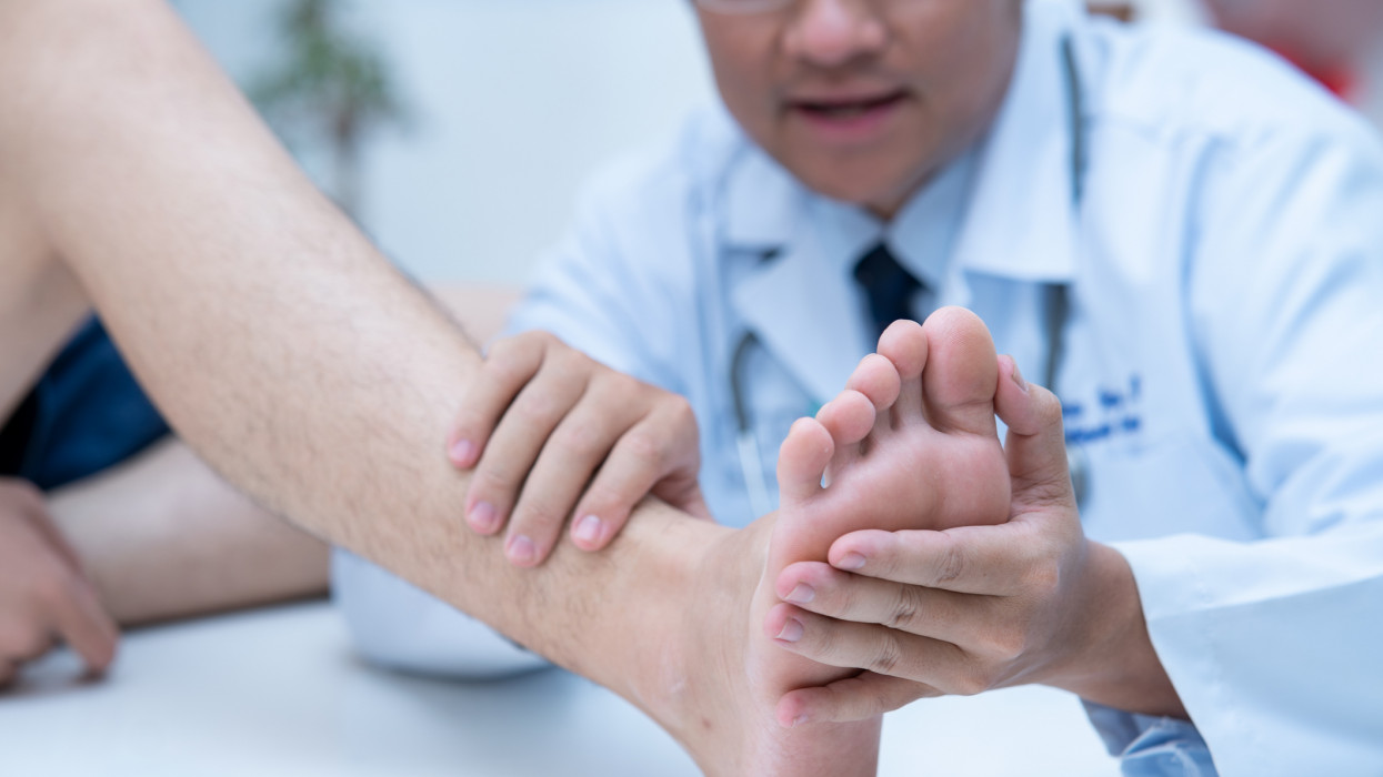 The doctor is examining the patients feet Doctor dermatologist examines the foot on the presence of athletes foot.