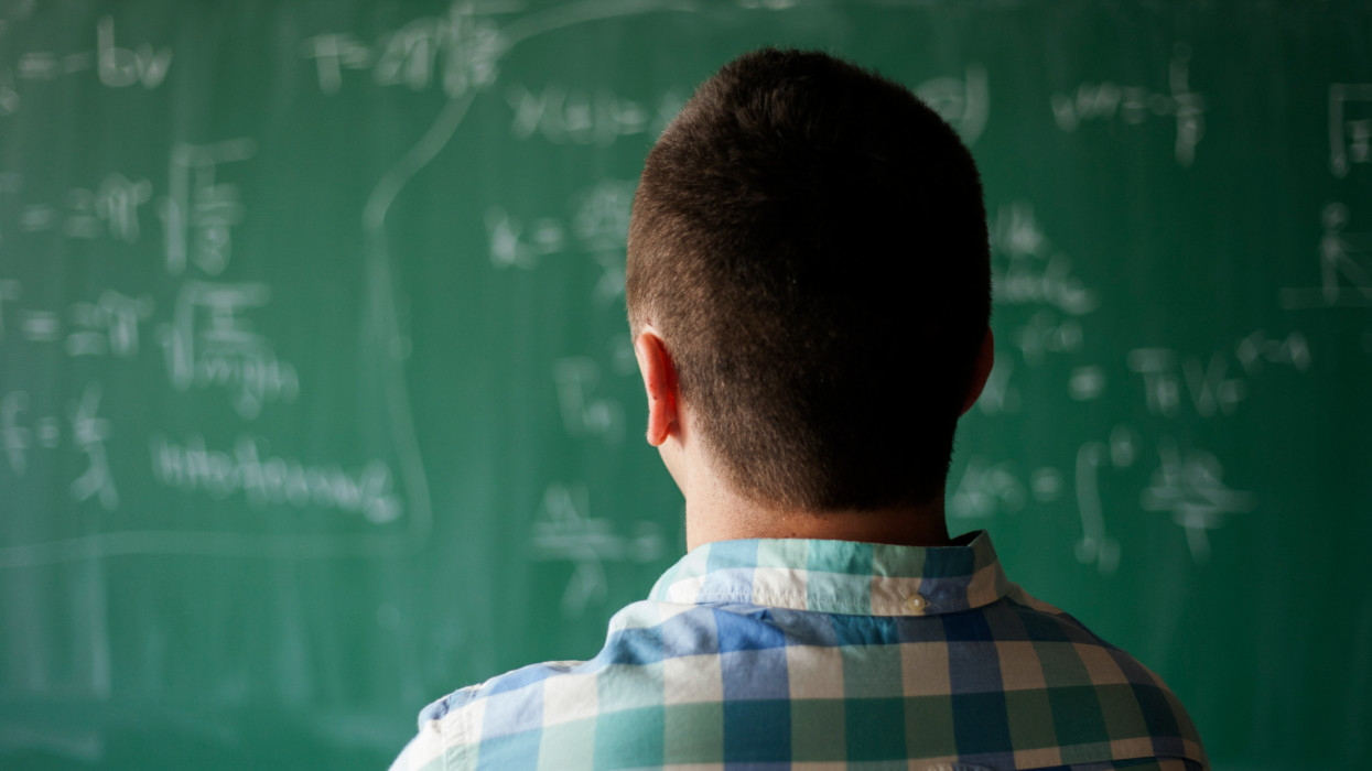 young professor in front of blackboard