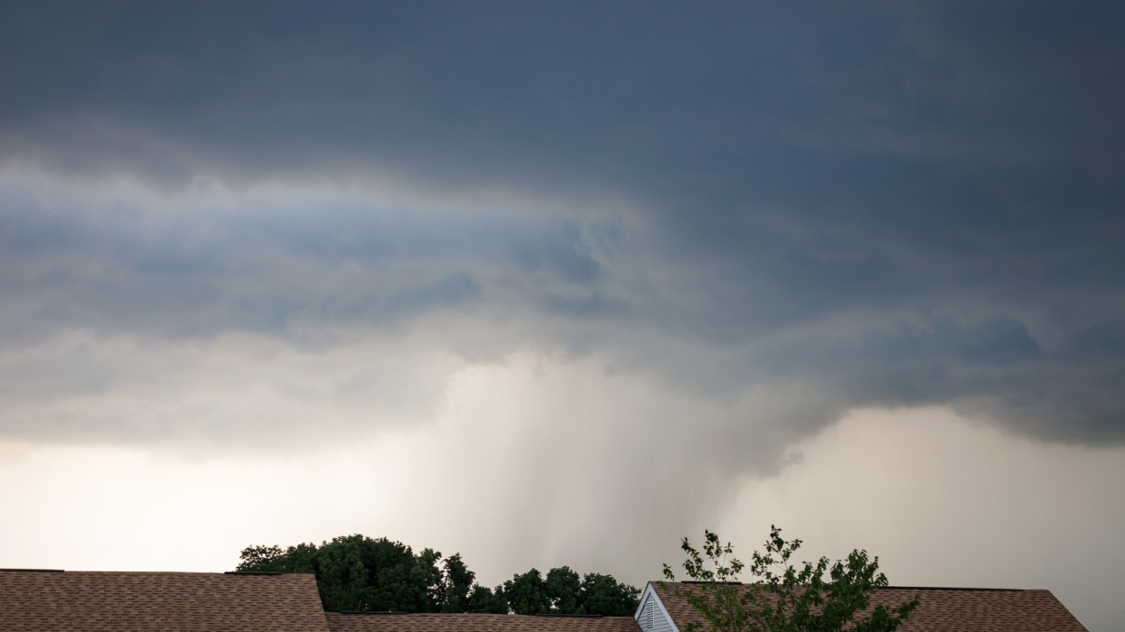 An approaching thunderstorm with a funnel of heavy rain in the distance.