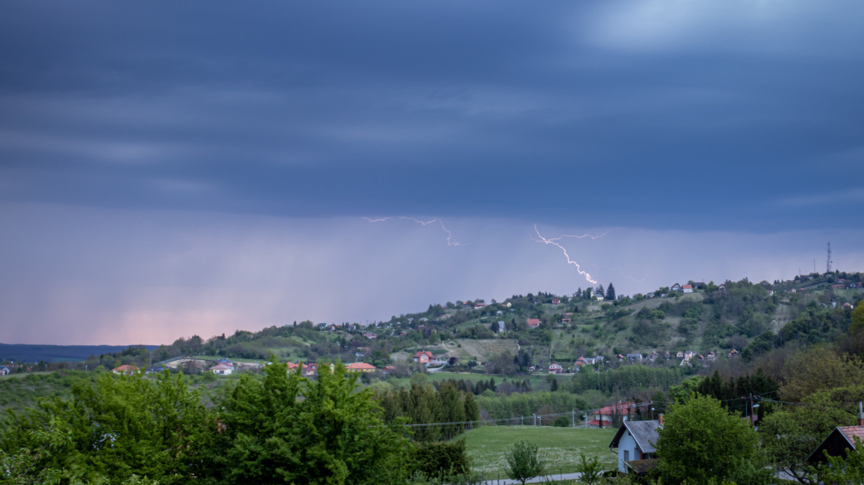 Lightning in a rain at hilly landscape, Hungary