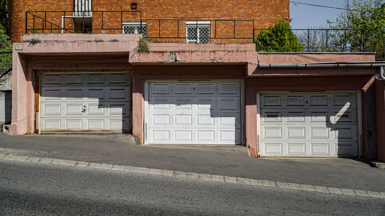 A set of garages under a residential building on a street in Budapest, Hungary