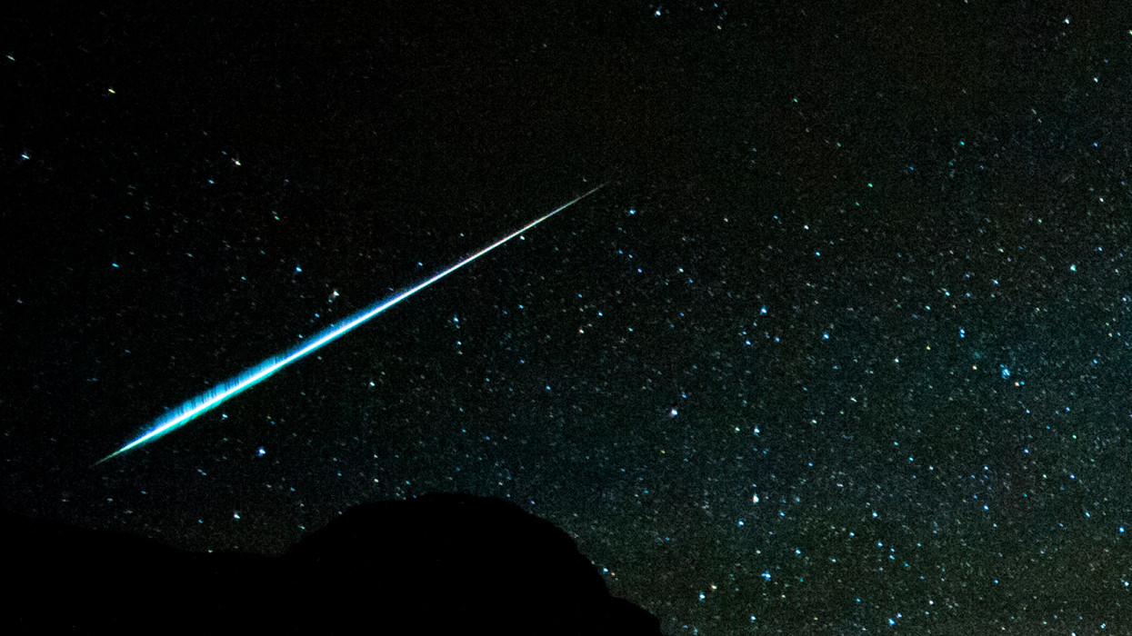 A bright Geminid meteor streaks through dark skies in the Sierra Nevada Mountains of California
