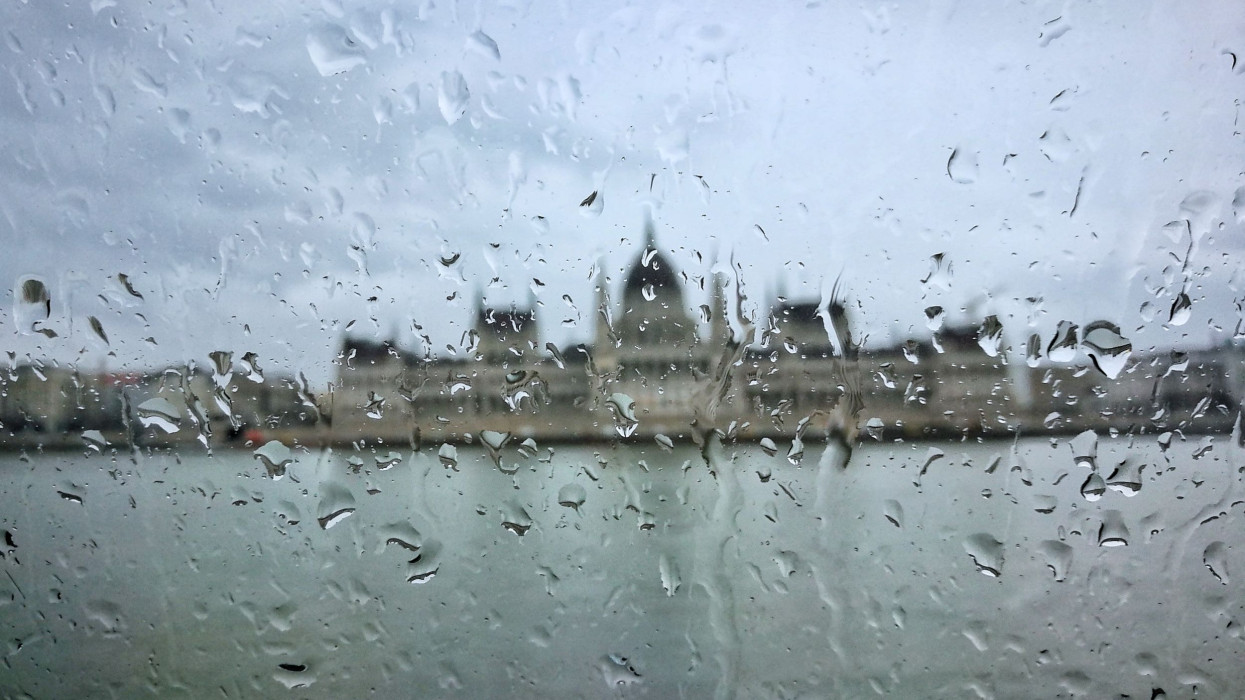 The Hungarian Parliament behind a raindrops covered window.