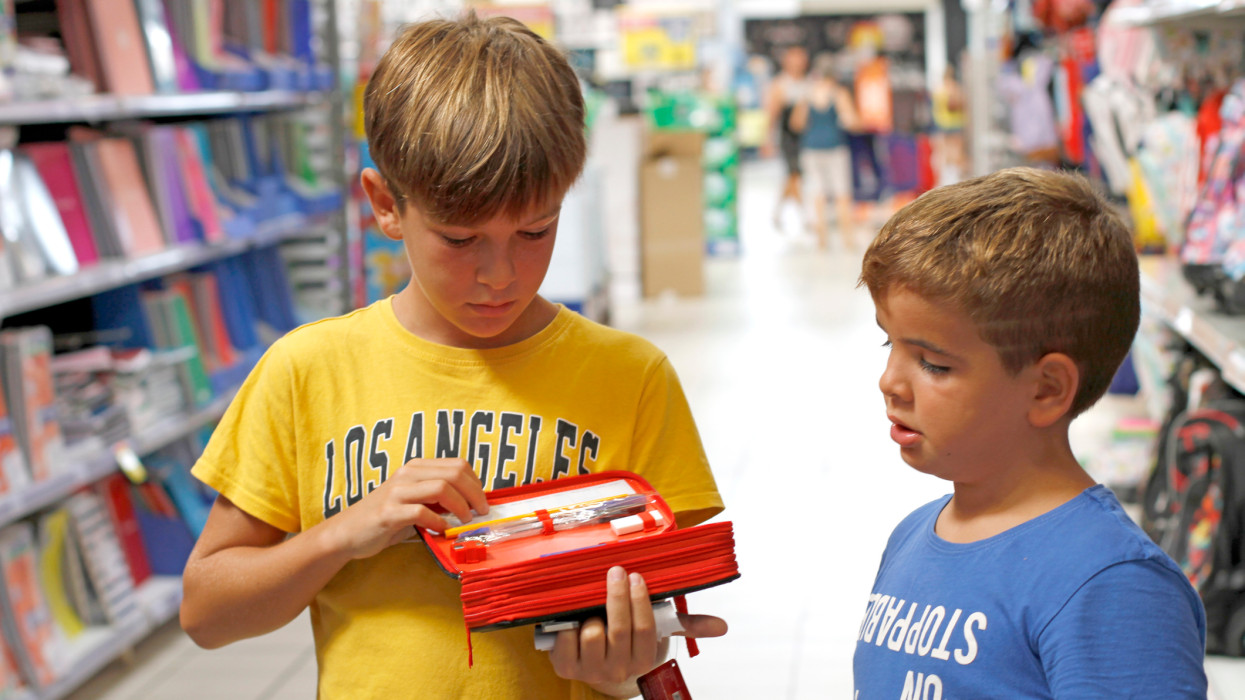 Children looking for back to school stationery in a store