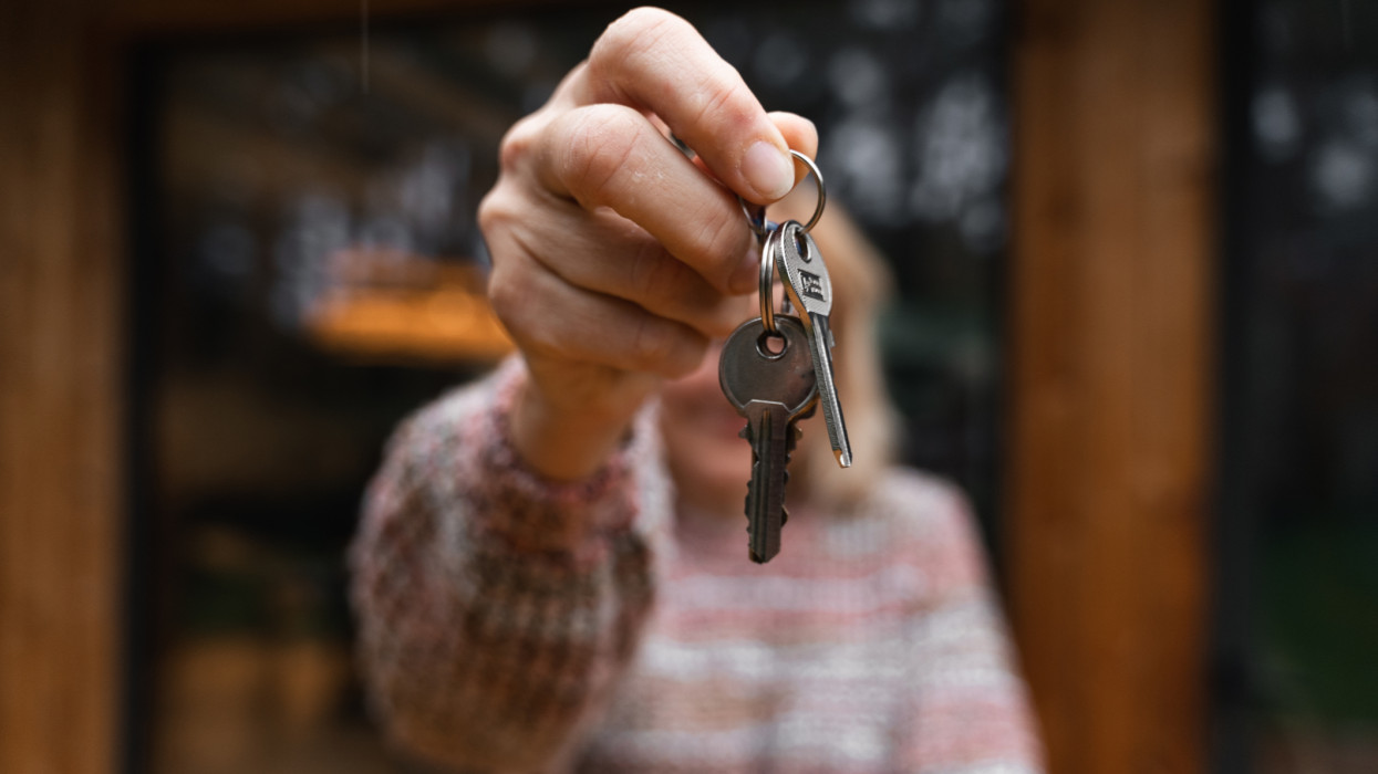 Mature woman holding keys after buying home