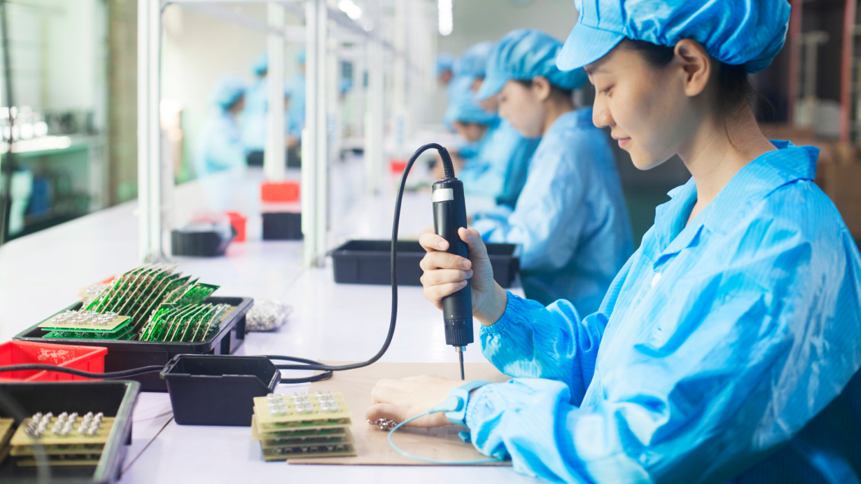 Workers in uniforms at a LED lighting factory in Dongguan, China
