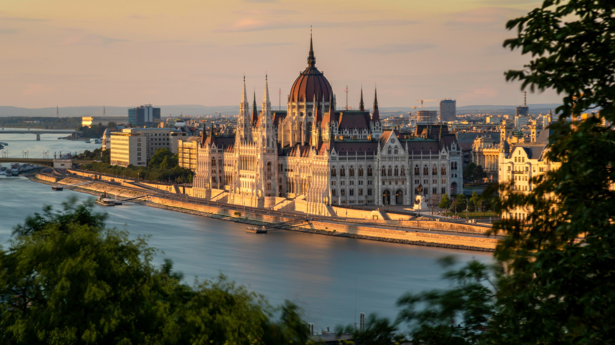 The Hungarian Parliament Building on the Banks of the Danube at sunset, Budapest, Hungary.