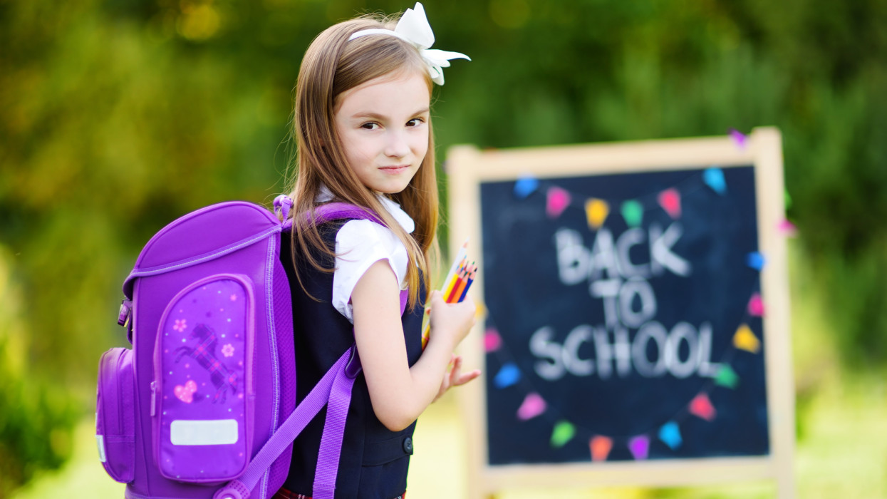 Adorable little girl feeling very exited about going back to school