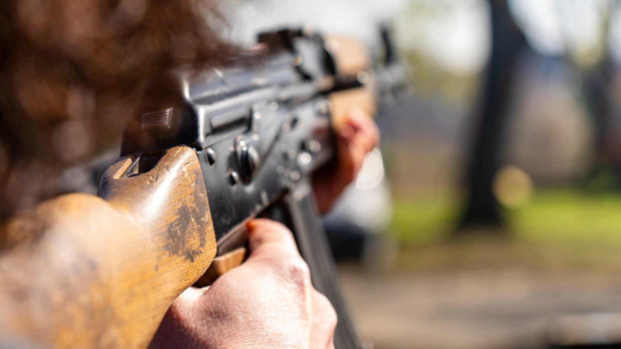 woman, takes aim, AK-47, Kalashnikov, assault rifle,
