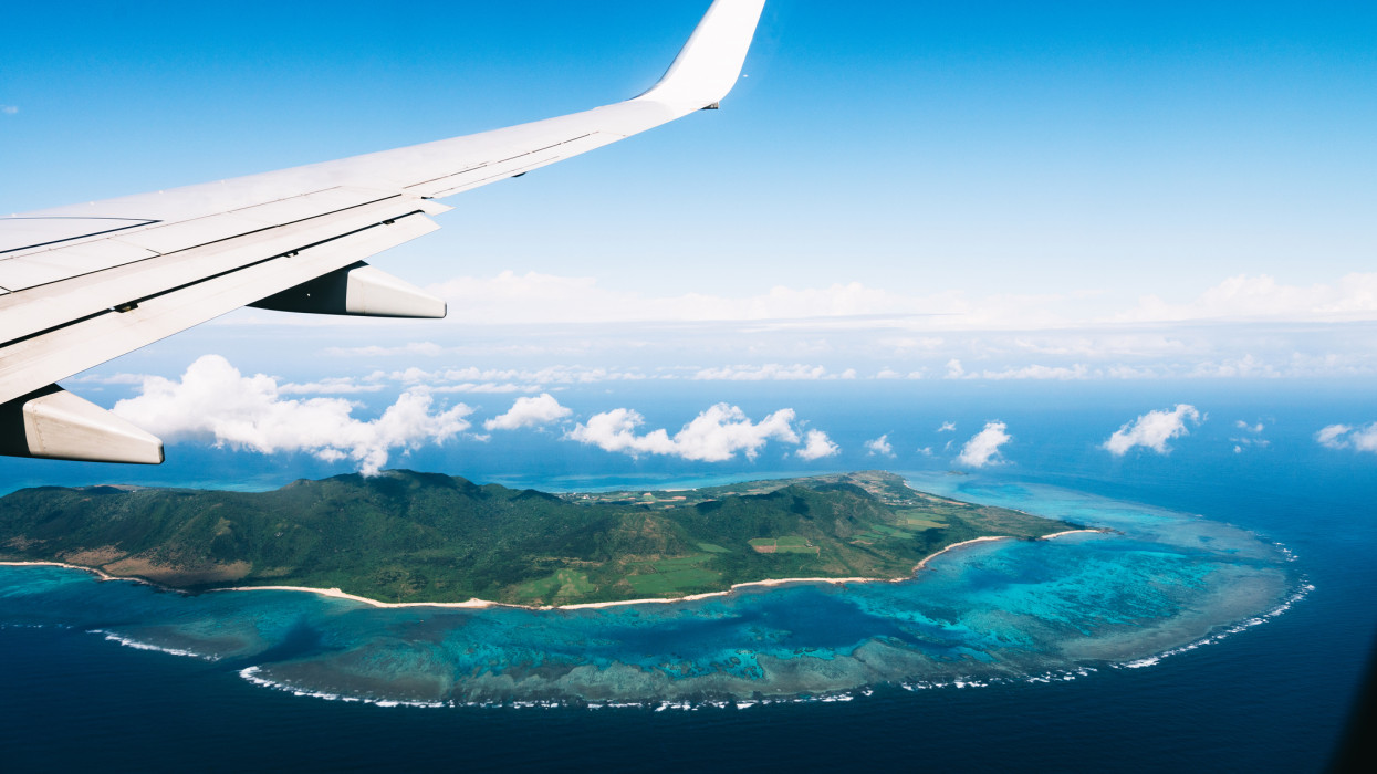 Flying over a tropical island with coral reefs, Ishigaki Island of the Yaeyama Islands, Okinawa, Japan