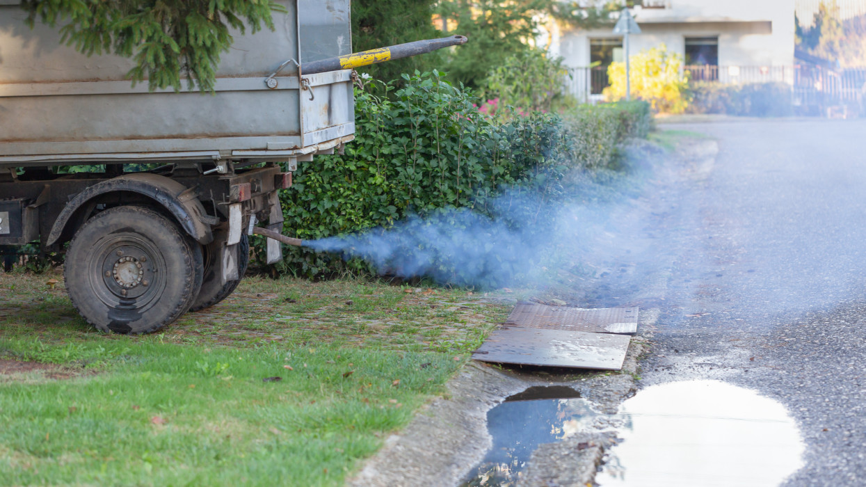 Toxic smoke from truck exhaust pipe. Truck parked in the countryside. Toxic exhaust polluting the environment. Ecological concept