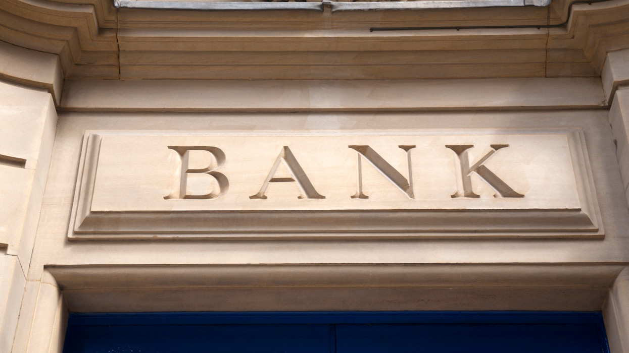 Closeup of Bank Sign on Yellow Stone Background