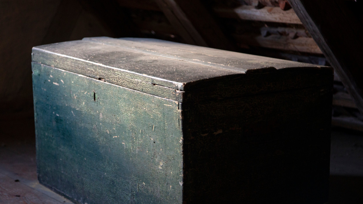 Dusty old wooden chest in the attic