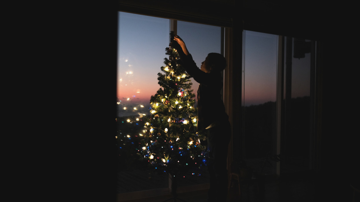 Decorating and lighting a Christmas tree at home