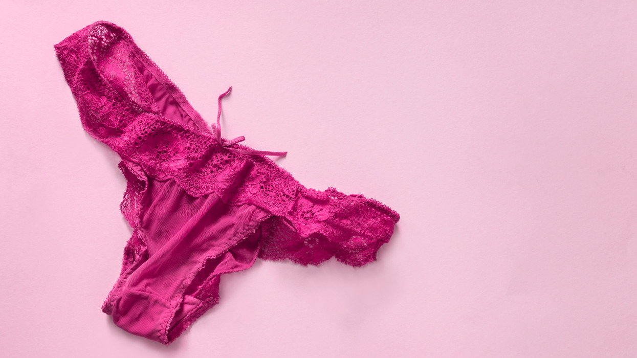 Magenta pink lacy wrinkled panty on pink background