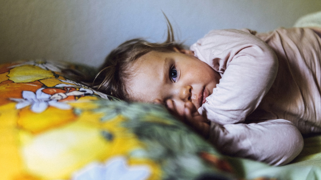 Beautiful toddler girl awaking after napping.