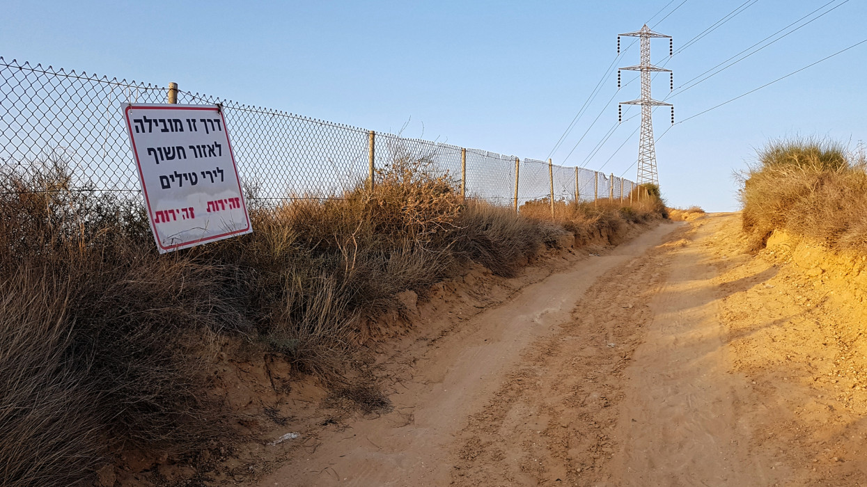 The Hebrew sign reads : This road leads to a rocket-exposed area. In red color : Be cautious.