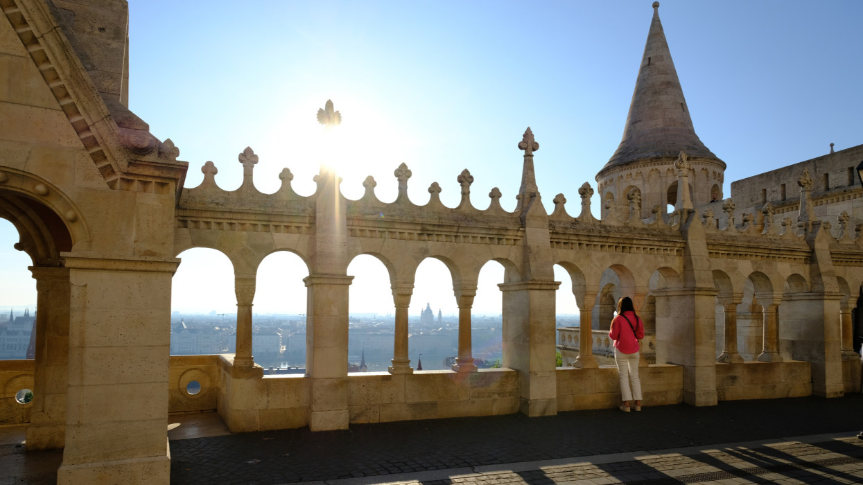 City of Budapest, young tourist observing the panorama from the fishermens bastion with the morning light.