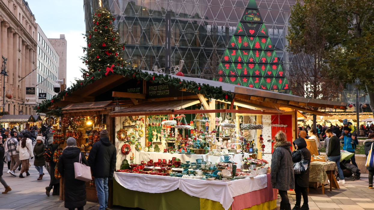 Budapest, Hungary - November 24, 2022: Crowded Christmas market, stalls selling handcrafted ceramic and artistic products in the annual Christmas market on the Vorosmarty square.