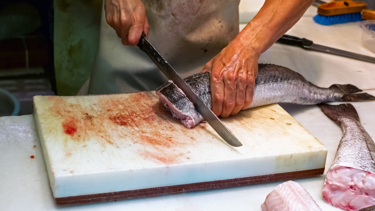 Man cutting fish on fish market