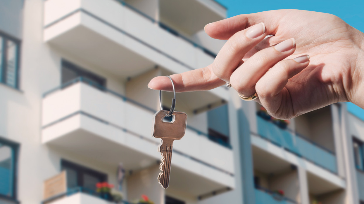 Real estate agent holding keys to new flat. Real estate, buy a home concept