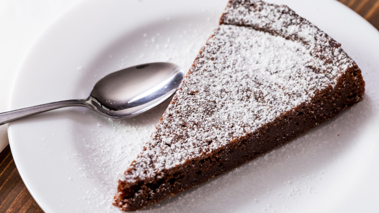 Chocolate Cake Slice on white dish and wooden background