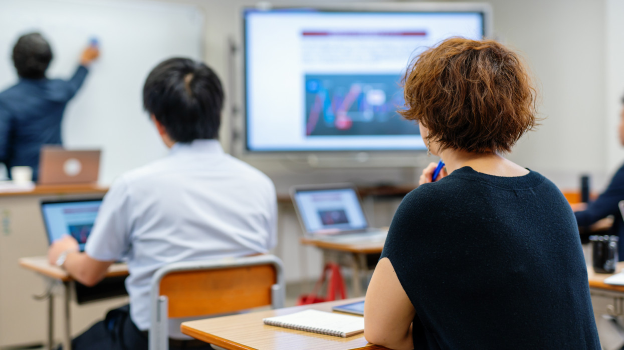 Mid adult woman in a continuing education class at a community college or university in Japan
