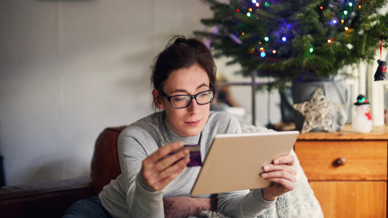 Young woman using a digital tablet Christmas shopping