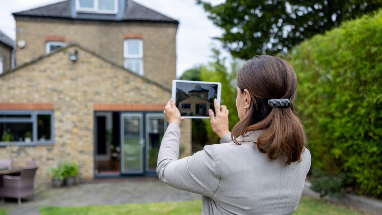 Real estate agent making a virtual tour of a house via using a tablet computer