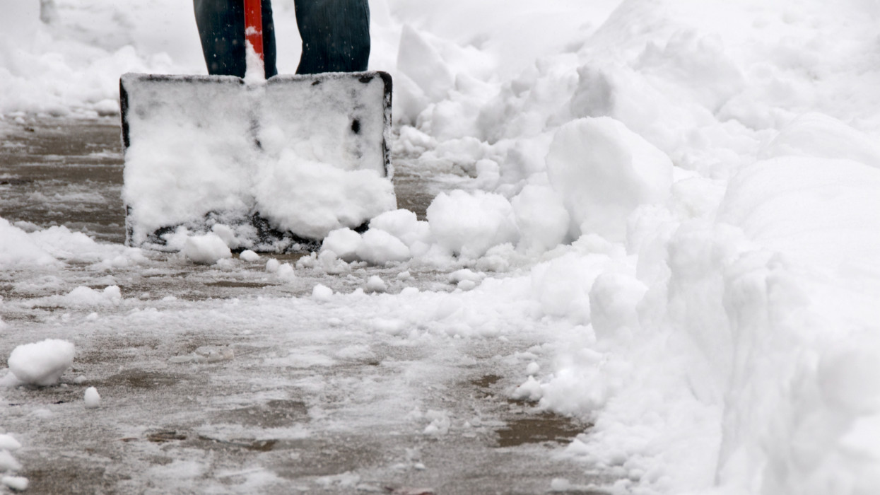 clearing heavy wet snow from the sidewalk after a winter storm.See more related images in my Winter Snow Removal lightbox: