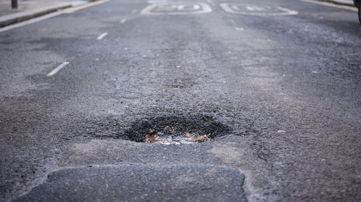 A large pot hole on residential street in North London