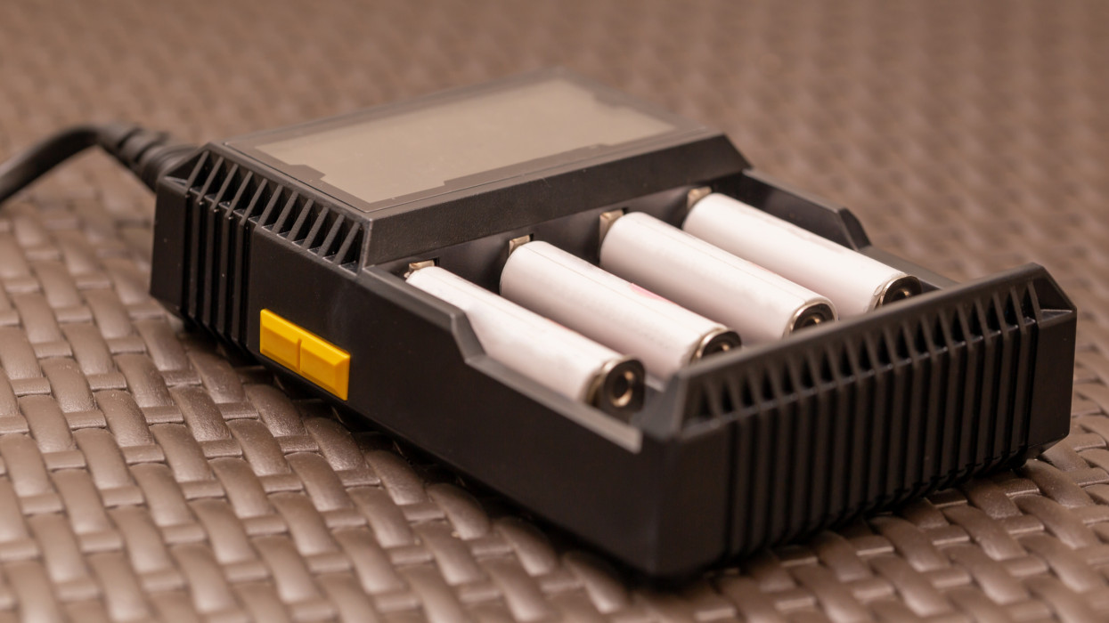 Stack of rechargeable AA batteries being recharged - Close up shot