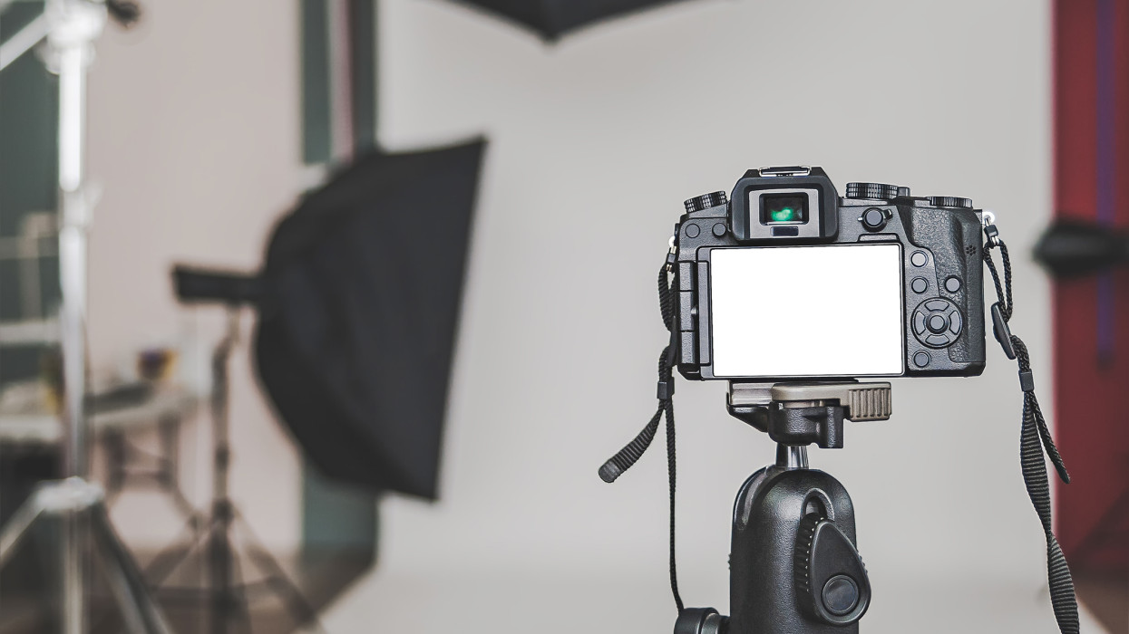 Mock up of a professional camera, in a photo studio, against the background of softbox light sources