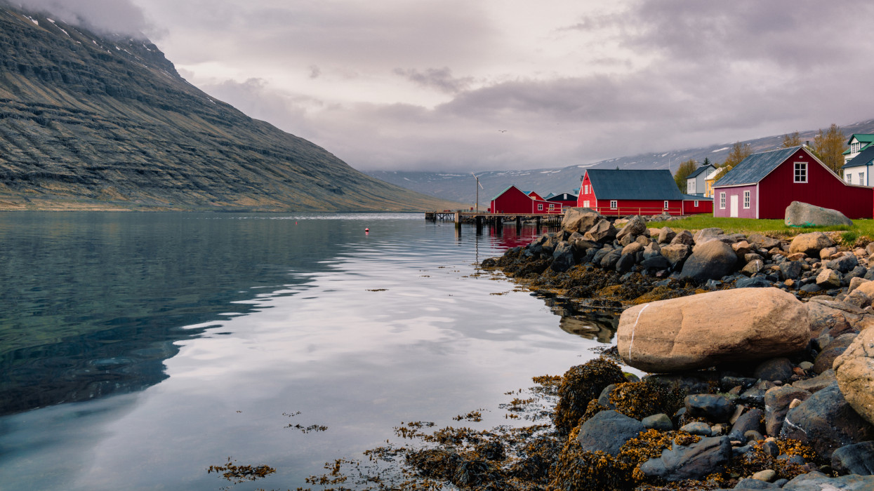 Eskifjordur is a charming seaside village in the mid of the eastern Fjords and the red-colored and well-preserved houses and fishing sheds lined up and down the shore provide an amazing view.