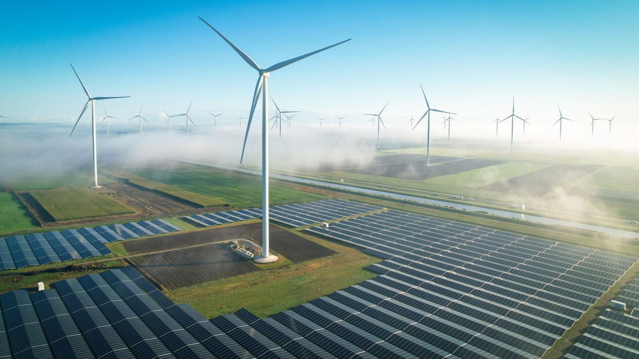 Solar energy fields and wind turbines seen from the air in foggy conditions during a Autumn morning.Muntendam, the Netherlands, september 2022