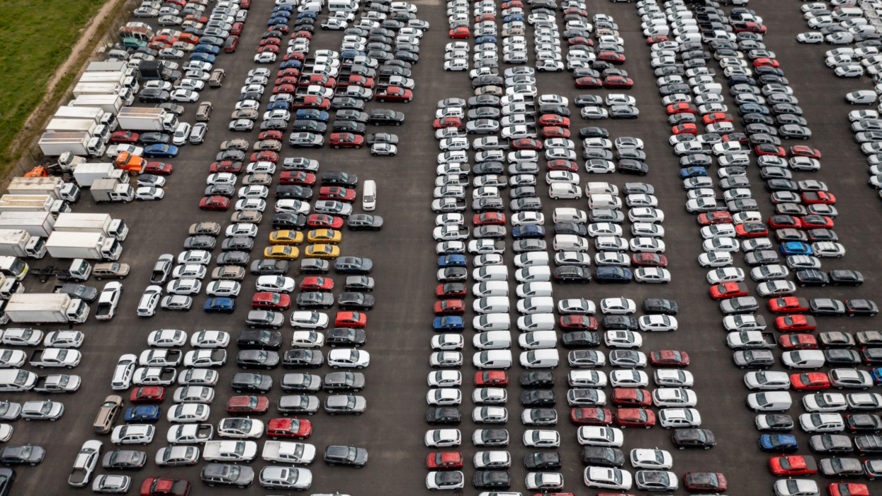Aerial shot of a car dealership parking lot full of vehicles for sale