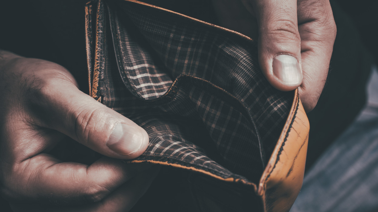 A Man Showing His Empty Wallet - No Money Left Concept